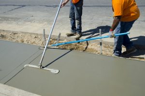 Workers laying concrete for a foundation in Queen Creek
